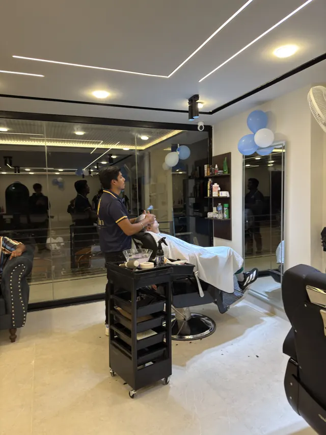 One of our barbers at work at his station