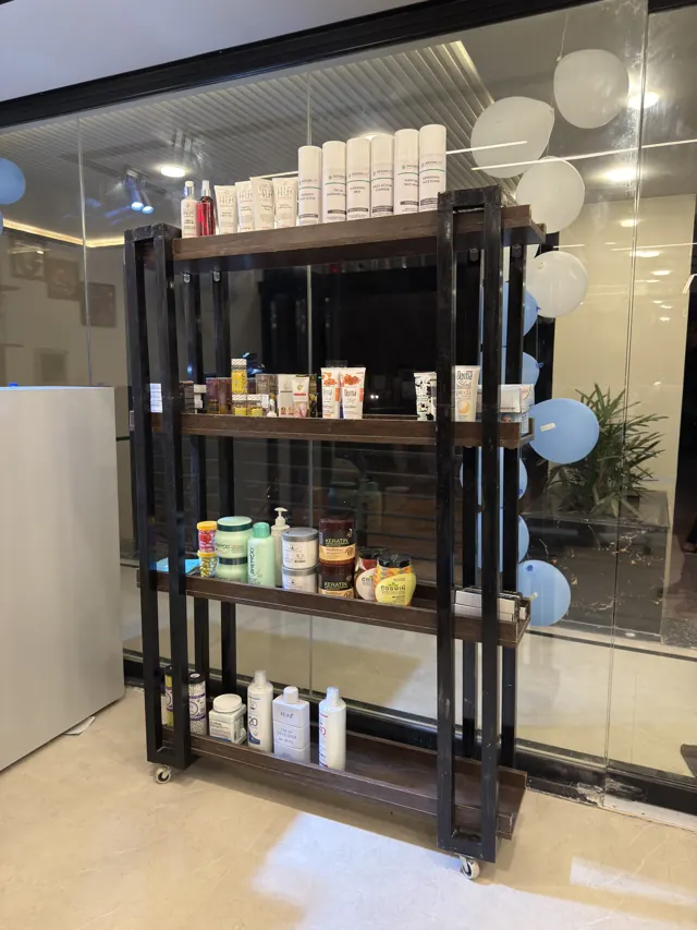 A shelf of grooming products by the glass wall